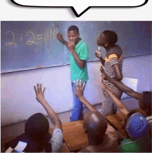 a group of people are raising their hands to answer a question on a blackboard that says 2 + 2 =