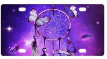 a purple background with a dream catcher and butterflies on it .