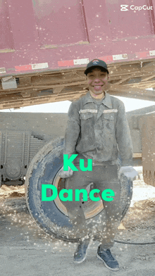 a man is holding a tire with the words ku dance written on it