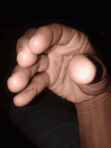 a close up of a person 's hand showing the thumb and index finger