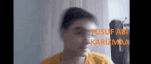 a blurry picture of a young boy with the name yusuf abi karizmaa written on it