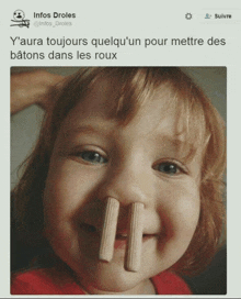 a little girl with two wooden sticks sticking out of her nose and a tweet from infos droles