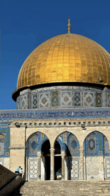 two men sit on the steps of a building with a dome that says ' ramadan ' on it