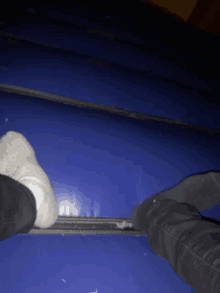 a person 's feet are on a blue mat