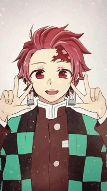 a boy with red hair and earrings is making a peace sign with his hands