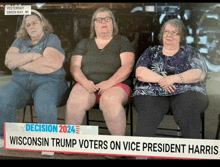 three women are sitting in front of a sign that says decision 2024