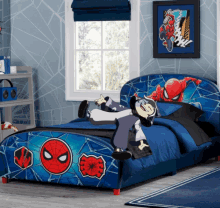 a bedroom with a spider man bed and a picture of spider man on the wall