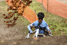 a man riding a bike with a shirt that says l' eau