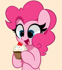 a pink pony is holding a cupcake with whipped cream and sprinkles