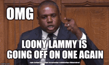 a man in a suit and tie is pointing at something and says omg loony lammy is going off on one again