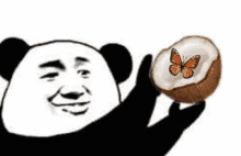 a panda is holding a slice of coconut with a butterfly on it .