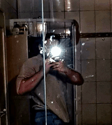 a man is taking a picture of himself in a mirror