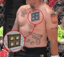 a shirtless man has a tattoo of a gun and a shield on his chest
