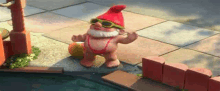 a garden gnome wearing sunglasses and a bikini is standing next to a pool .