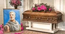 a coffin with flowers and a picture of a man on it .