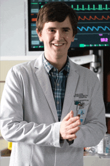 a man wearing a lab coat with the name frederick on the front