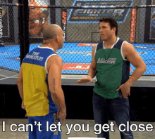 a man in a green ultimate fighter shirt talks to another man in a yellow and blue tank top