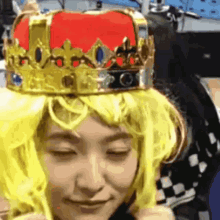 a woman wearing a yellow wig and a crown on her head