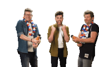 three men are standing next to each other holding bottles of orange juice