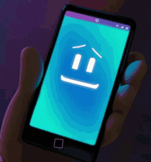 a person is holding a smart phone with a sad face on the screen