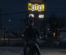 a man is riding a motorcycle in front of a sign that says motel