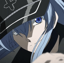 a close up of a person with blue hair and a hat with a cross on it