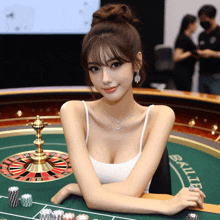 a woman sits in front of a roulette table that says ballys