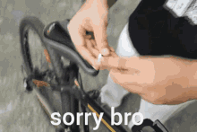 a person is fixing a bicycle with the words sorry bro below