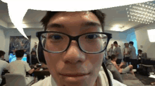 a man wearing glasses and a headset is making a funny face .