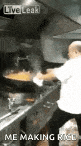 a man is cooking rice in a wok in a kitchen with the words `` me making rice '' written below him .
