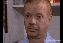 a close up of a man 's face with the words minimx on the bottom right corner