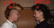 two men with mohawks are standing next to each other and one of them has the word kins on his head