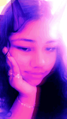 a close up of a girl 's face with a pink background