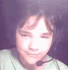 a young boy wearing a headset and a microphone .