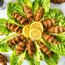 a plate of food with lettuce and lemon slices on top