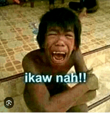 a shirtless child is crying with the words ikaw nah written on the bottom