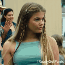 a woman with braids in her hair is wearing a blue tank top with #readysetpanic written on the bottom