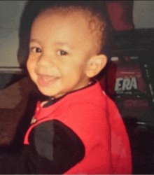 a young boy wearing a red shirt with the word era on the back