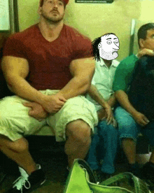 a man with very large muscles sits next to a woman with a cartoon face on her face