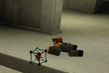 a video game character is laying on the ground next to a cube