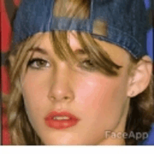 a close up of a woman 's face wearing a hat .