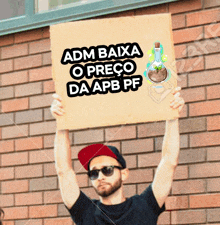 a man holding a sign that says adm baixa o preço da apb pf