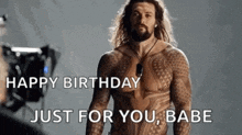 a man with a beard is standing in front of a camera and says happy birthday just for you babe .