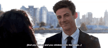 a man in a suit and tie is smiling at a woman in front of a city skyline .