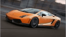 an orange lamborghini is driving down a road