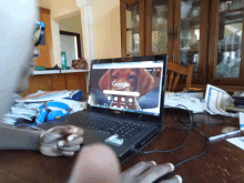 a person is typing on a laptop with a picture of a dog on the screen that says google