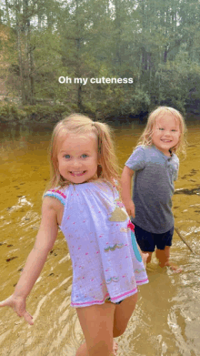 two little girls are standing in the water with the caption oh my cuteness above them