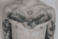 a man has a tattoo of an eagle spreading its wings on his chest