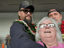 a man with a beard wearing a hei hat stands next to a woman with glasses