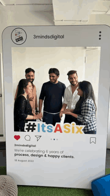 a group of people standing in front of a photo frame that says #itsasix on it